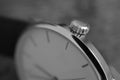 Black and white macro detail of a golden indented crown set in the gold-plated watch as a symbol of luxurious timepiece Royalty Free Stock Photo