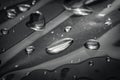 Black and white macro photo of water drops scattered on reflective metal surface Royalty Free Stock Photo