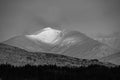 Black and white Majestic Alpen Glow hitting mountain peaks in Scottish Highlands during stunning Winter landscape sunrise Royalty Free Stock Photo