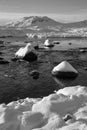 Black and white Beautiful Winter landscape image looking towards Scottish Highlands mountain range across Loch Ba on Rannoch Moor Royalty Free Stock Photo