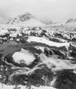 Black and white Majestic Winter landscape image of River Etive in foreground with iconic snowcapped Stob Dearg Buachaille Etive Royalty Free Stock Photo