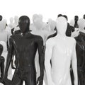 Black and white male mannequin at the head of a group of other mannequins. 3D rendering Royalty Free Stock Photo