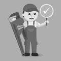 Black and white male plumber holding a true sign and giant pipe wrench Royalty Free Stock Photo