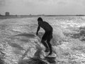 Black and white of male wake surfing at sea Royalty Free Stock Photo