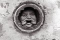 Black and white Man`s face in hole at brick wall in Melbourne. Royalty Free Stock Photo