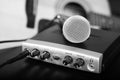 Black and white microphone on home recording studio with guitar