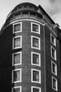 Black and white monochrome image looking up at modern red brick apartment building Royalty Free Stock Photo