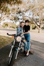 Portrait of Attractive Good Looking Young Modern Trendy Fashionable Guy Girl Couple Riding on Green Motorcycle Cruiser Old School