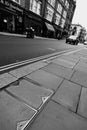 Black and White, monochrome, tilted view of city street with double yellow lines and blurred background Royalty Free Stock Photo