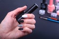 Black, white Nail art manicure. Holiday style bright Manicure with sparkles. Bottle of Nail Polish. Beauty hands Royalty Free Stock Photo