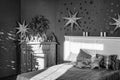 Black and white, New Year`s interior. Bedroom with fireplace decorated with Christmas stars. Sweet home Royalty Free Stock Photo