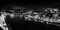 Black and white night cityscape panorama of Porto old town and river Douro banks skyline with water reflections in Porto, Portugal Royalty Free Stock Photo