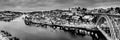 Black and white night cityscape panorama skyline of Porto old town, Luis I Bridge and river Douro banks with reflections Royalty Free Stock Photo