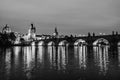 Black and white night landscape of Charles Bridge and its reflactions in the Vltava river in Prague, Czech Republic Royalty Free Stock Photo