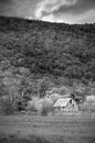 Black & White Old Barn in the Mountains with Stormy Sky Royalty Free Stock Photo