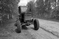 Black and white farm tractor parked on the side of the road Royalty Free Stock Photo