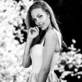 Black-white outdoor portrait of beautiful young sexual blonde woman against nature background