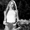 Black-white outdoor portrait of beautiful young sexual blonde woman against nature background