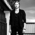 Black-white outdoor portrait of elegant long hair handsome man Royalty Free Stock Photo