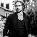 Black-white outdoor portrait of elegant long hair handsome man Royalty Free Stock Photo