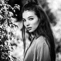 Black-white outdoors portrait of beautiful emotional positive young woman