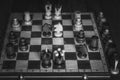 Black and white overhead shot of a wooden chess board with some pieces on it Royalty Free Stock Photo