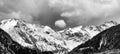 Black and white panorama mountain landscape with snowcapped peaks and expressive cloudscape Royalty Free Stock Photo
