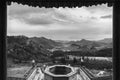 Black and white panorama view of a valley through the gate of a buddhist temple in Mongolia