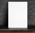 Black White paper poster lean at black brick wall and marble tab Royalty Free Stock Photo