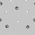 Black and white paw print repeated pattern with gray background Royalty Free Stock Photo
