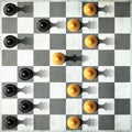 Black in And white pawn with the shadow of the queen, in front of the pawns. Top view. Leadership concept. Strength and Royalty Free Stock Photo