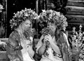 Black and white phot girls in large flower wreaths, Ukrainian national scarves