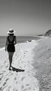 Black and white photo of amazing beach landscape view with beautiful back view of model lady. generative ai