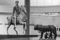 Black and white photo of ancient roman iconic sculptures displayed inside a museum in Italy