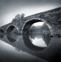 Black and white photo of ancient Romanesque bridge