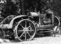 Antique steel wheel farm tractor under a shade tree