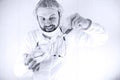 Black and white photo of bearded doctor in white coat and an ol Royalty Free Stock Photo