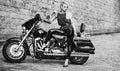 Black and white photo of beautiful biker women posing with motorcycle. Royalty Free Stock Photo