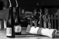 Black and white photo of bottles with olive oil in restaurant interior