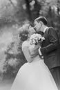 Black and white photo of bride groom kissing in a forest Royalty Free Stock Photo