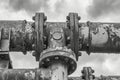 This black and white photo captures the detailed features and texture of an aging pipe, Monochrome depiction of an old, rusty