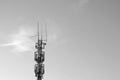 Black and white photo. Cell tower against the sky. Modern technologies. Royalty Free Stock Photo