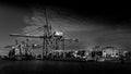 Black and White Photo of Container Port with the Large Container Cranes loading a Ocean Going Freighter in Vancouver Harbor