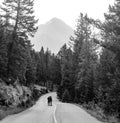 couple together in middle of road in front of mountain background Royalty Free Stock Photo