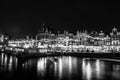 Black-white photo of cruise boat moving on night canals of Amsterdam in Amsterdam, Netherlands. Royalty Free Stock Photo