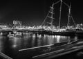 Black-white photo of cruise boat moving on night canals of Amsterdam in Amsterdam, Netherlands. Royalty Free Stock Photo