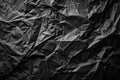 A black and white photo of crumpled paper with sharp creases and folds, Crumpled black paper with sharp creases and folds