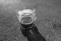 Black and white photo. A cup of fresh coffee. Shadow from the cup. Royalty Free Stock Photo