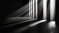 A black and white photo of a dark room with light coming through the windows Royalty Free Stock Photo