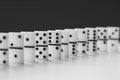 Black and white photo of a domino board game. Knuckles of dominoes in a row Royalty Free Stock Photo
